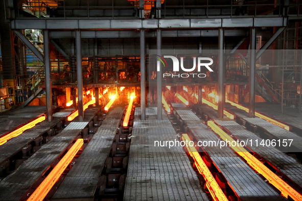 A worker is working at a steel casting workshop of a steel company in Lianyungang, China, on July 13, 2024. 