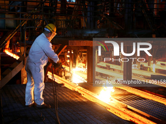 A worker is working at a steel casting workshop of a steel company in Lianyungang, China, on July 13, 2024. (