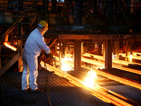 A worker is working at a steel casting workshop of a steel company in Lianyungang, China, on July 13, 2024. (