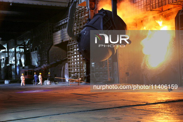 A worker is working at a steel casting workshop of a steel company in Lianyungang, China, on July 13, 2024. 