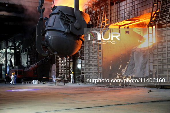 A worker is working at a steel casting workshop of a steel company in Lianyungang, China, on July 13, 2024. 