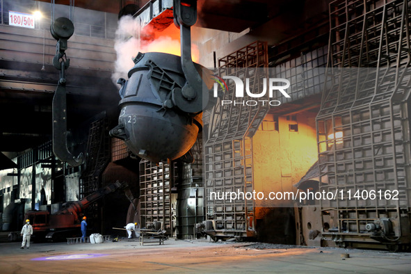 A worker is working at a steel casting workshop of a steel company in Lianyungang, China, on July 13, 2024. 