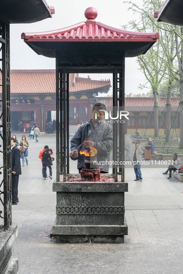 Visitors are praying with incense burning for their happiness at Lingshan Temple in Wuxi, China. 