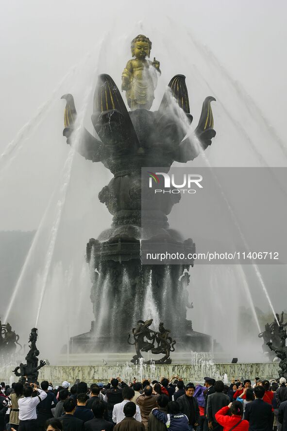 Visitors are praying for washing performance for their happiness at Lingshan Temple in Wuxi, China. 