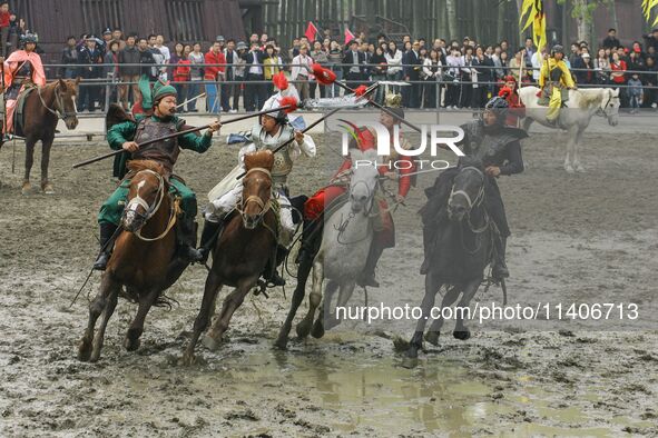 Actors are performing a cavalry battle from the Three Kingdoms era at the CCTV filming location in Wuxi, China. 