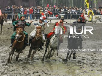 Actors are performing a cavalry battle from the Three Kingdoms era at the CCTV filming location in Wuxi, China. (