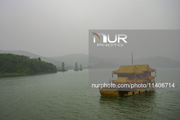 A Chinese traditional ship is sailing on Lake Tai in Wuxi, China. 