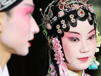 An actor and actress are performing in a Beijing opera at a traditional theatre in Suzhou, China. (