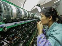 A worker is making silk at a factory in an industrial park in Suzhou, China. (