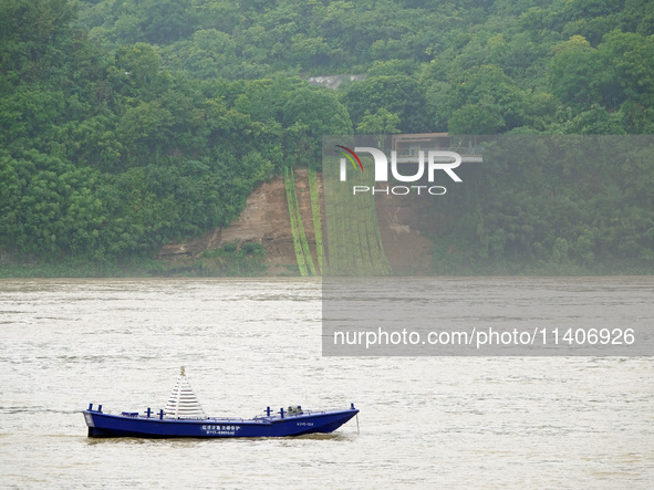 A landslide is occurring near the viewing platform of Mojishan Park on the banks of the Yangtze River in Yichang, Hubei province, China, on...