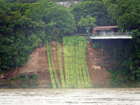 A landslide is occurring near the viewing platform of Mojishan Park on the banks of the Yangtze River in Yichang, Hubei province, China, on...