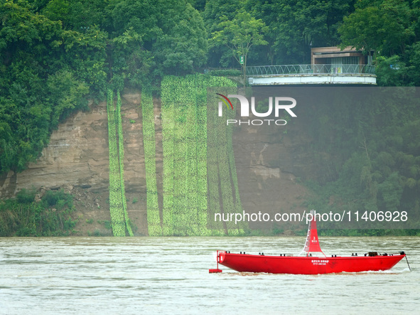 A landslide is occurring near the viewing platform of Mojishan Park on the banks of the Yangtze River in Yichang, Hubei province, China, on...