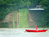 A landslide is occurring near the viewing platform of Mojishan Park on the banks of the Yangtze River in Yichang, Hubei province, China, on...