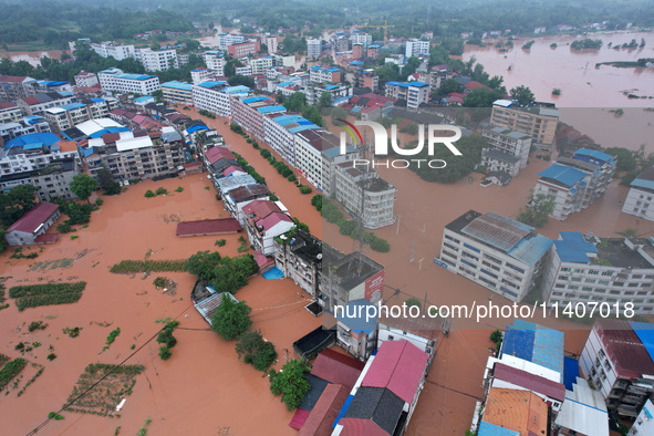 Flood waters are surrounding the field of Tianjia town in Neijiang, China, on July 14, 2024. 