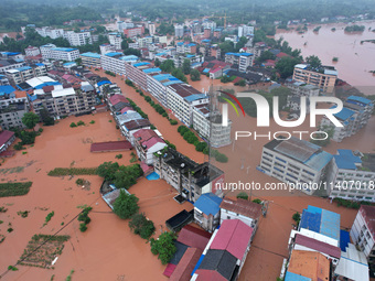 Flood waters are surrounding the field of Tianjia town in Neijiang, China, on July 14, 2024. (