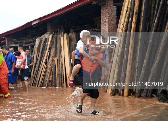 Emergency workers are evacuating stranded people in Neijiang, China, on July 14, 2024. 