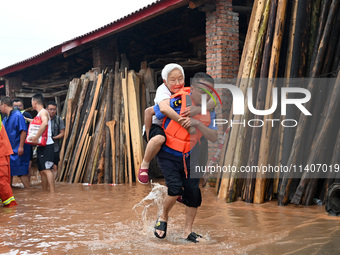 Emergency workers are evacuating stranded people in Neijiang, China, on July 14, 2024. (