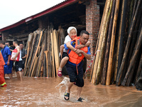 Emergency workers are evacuating stranded people in Neijiang, China, on July 14, 2024. (