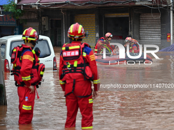 Emergency workers are evacuating stranded people in Neijiang, China, on July 14, 2024. (