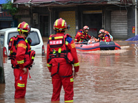 Emergency workers are evacuating stranded people in Neijiang, China, on July 14, 2024. (