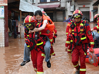 Emergency workers are evacuating stranded people in Neijiang, China, on July 14, 2024. (