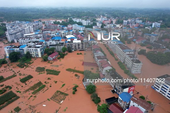 Flood waters are surrounding the field of Tianjia town in Neijiang, China, on July 14, 2024. 