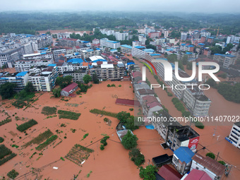 Flood waters are surrounding the field of Tianjia town in Neijiang, China, on July 14, 2024. (