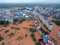 Flood waters are surrounding the field of Tianjia town in Neijiang, China, on July 14, 2024. (