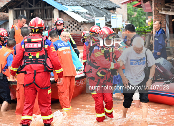 Emergency workers are evacuating stranded people in Neijiang, China, on July 14, 2024. 