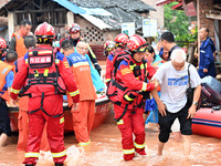 Emergency workers are evacuating stranded people in Neijiang, China, on July 14, 2024. (