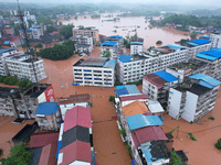 Emergency workers are evacuating stranded people in Neijiang, China, on July 14, 2024. (