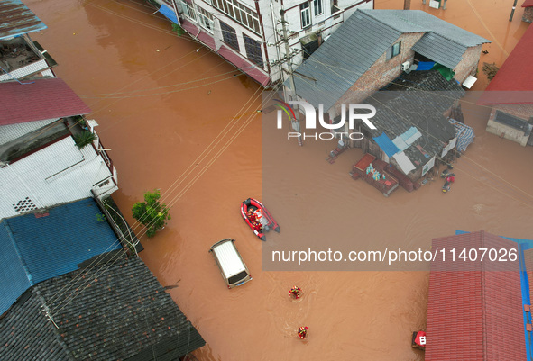 Emergency workers are evacuating stranded people in Neijiang, China, on July 14, 2024. 