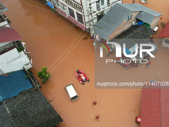 Emergency workers are evacuating stranded people in Neijiang, China, on July 14, 2024. (