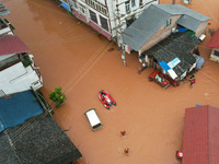 Emergency workers are evacuating stranded people in Neijiang, China, on July 14, 2024. (