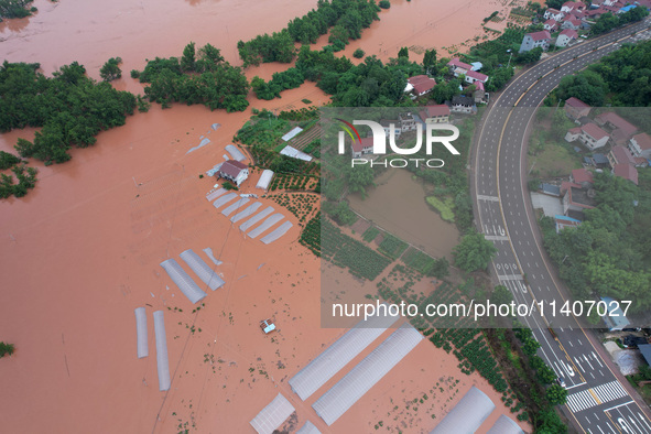 Farmland is flooding along the Xiaoqinglong River at Gaoqiao Street in Neijiang, China, on July 14, 2024. 