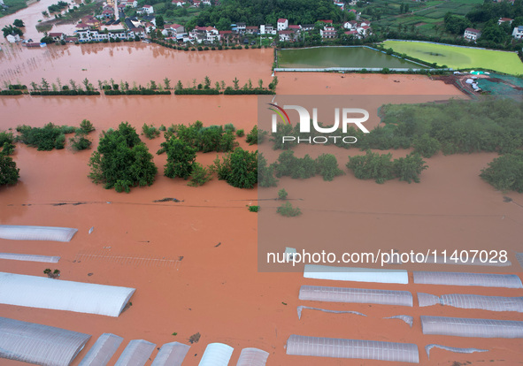 Farmland is flooding along the Xiaoqinglong River at Gaoqiao Street in Neijiang, China, on July 14, 2024. 