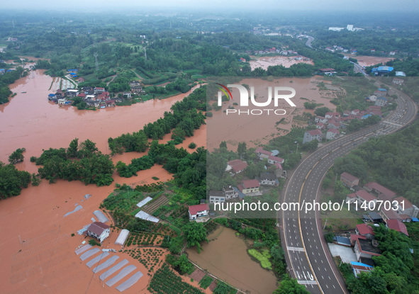 Farmland is flooding along the Xiaoqinglong River at Gaoqiao Street in Neijiang, China, on July 14, 2024. 