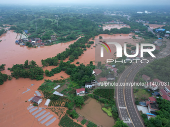 Farmland is flooding along the Xiaoqinglong River at Gaoqiao Street in Neijiang, China, on July 14, 2024. (