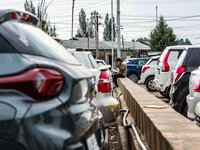 A man is speaking on his phone as he is sitting inside a car parking area in Srinagar, Jammu and Kashmir, India, on July 14, 2024. (