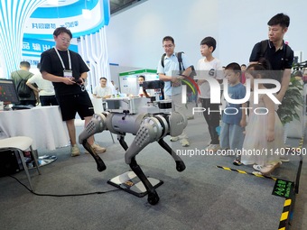 Visitors are visiting a ''four-legged robot'' at the 26th China Beijing International Science and Technology Industry Expo in Beijing, China...