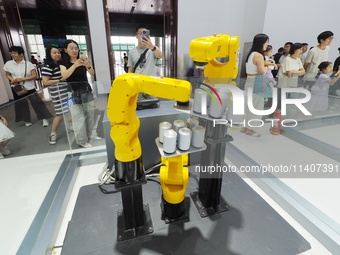 Visitors are visiting a ''six-axis industrial robot'' at the 26th China Beijing International Science and Technology Industry Expo in Beijin...