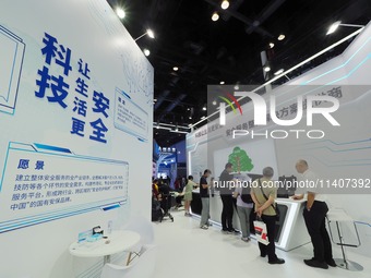 Visitors are viewing security technology products at the 26th China Beijing International Science and Technology Expo in Beijing, China, on...