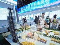 Visitors are visiting a model of a ''biomass bale-fired direct-fired boiler'' at the 26th China Beijing International Science and Technology...