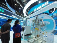 Visitors are visiting a ''special operation robot'' at the 26th China Beijing International Science and Technology Industry Expo in Beijing,...