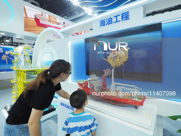 Visitors are viewing a model of ''Offshore Oil 286'' at the 26th China Beijing International Science and Technology Industry Expo in Beijing...