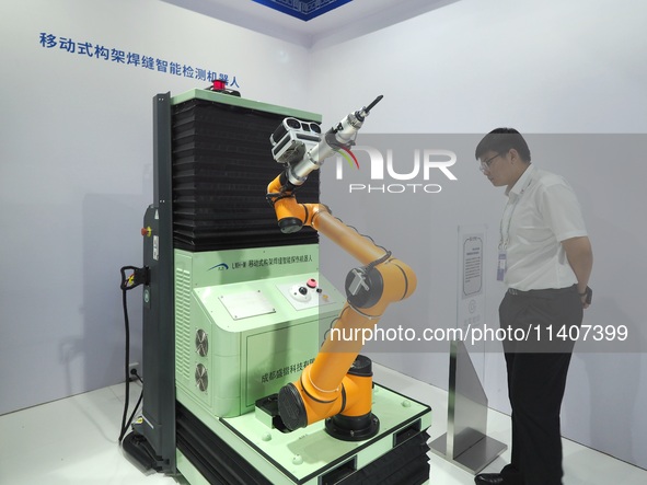 Visitors are visiting a ''Mobile frame weld intelligent inspection robot'' at the 26th China Beijing International Science and Technology In...