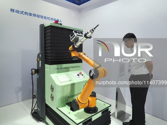 Visitors are visiting a ''Mobile frame weld intelligent inspection robot'' at the 26th China Beijing International Science and Technology In...