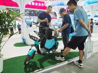 Visitors are visiting a ''hydrogen-powered moped'' at the 26th China Beijing International Science and Technology Industry Expo in Beijing,...