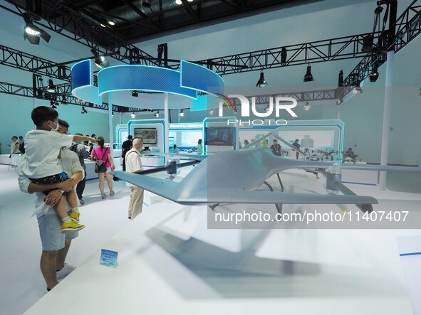 Visitors are visiting a ''vertical take-off and landing UAV'' at the 26th China Beijing International Science and Technology Industry Expo i...