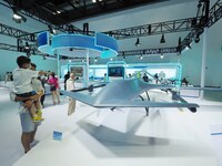 Visitors are visiting a ''vertical take-off and landing UAV'' at the 26th China Beijing International Science and Technology Industry Expo i...